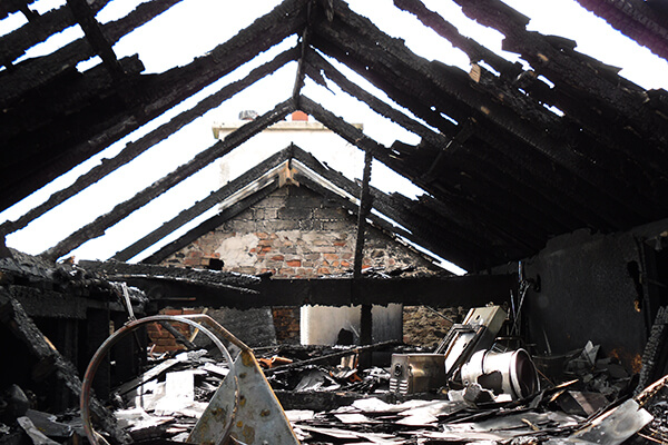 Fire gutted roof with sky visible