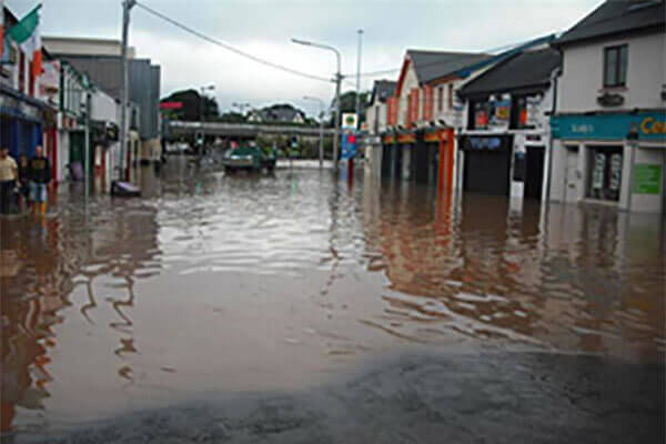 Flooded street with extensive property damage